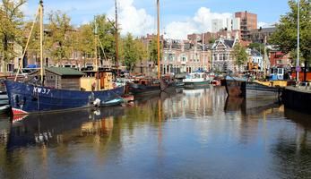 The Groningen waterfront with sailboats, residental homes, and larger buildings in the background.