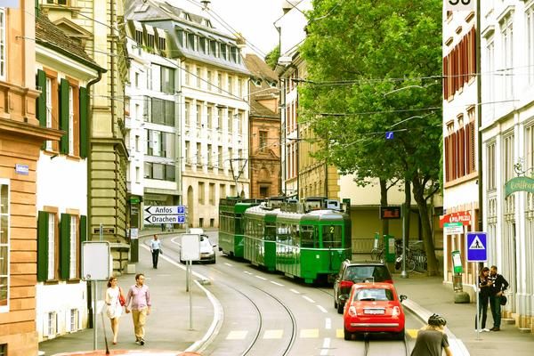 Photo of a tram winding through the streets of Basel.