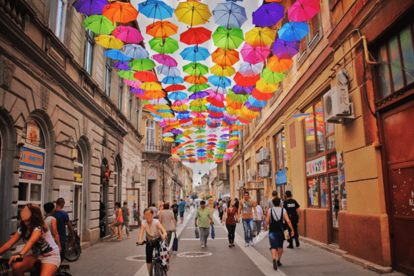 A street in Bucharest filled with pedestrians and cyclists