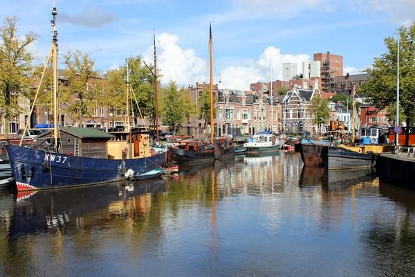 The Groningen waterfront with sailboats, residental homes, and larger buildings in the background.