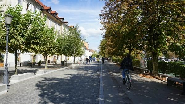Man cycling through public square in Slovenia