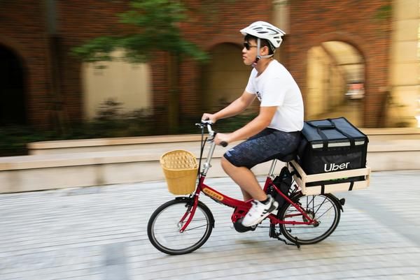 Man on a bicycle with a basket on the back