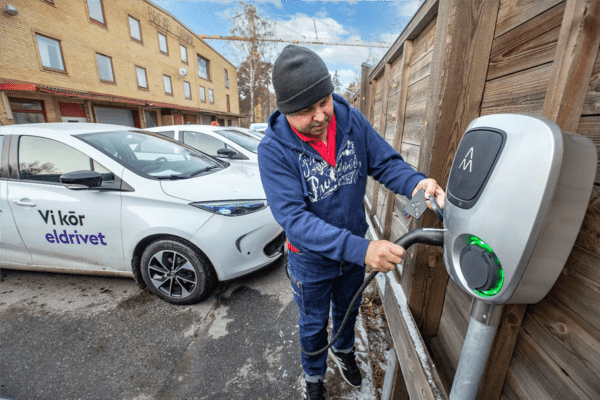 A man charging his e-vehicle in Bromma, Stockholm.