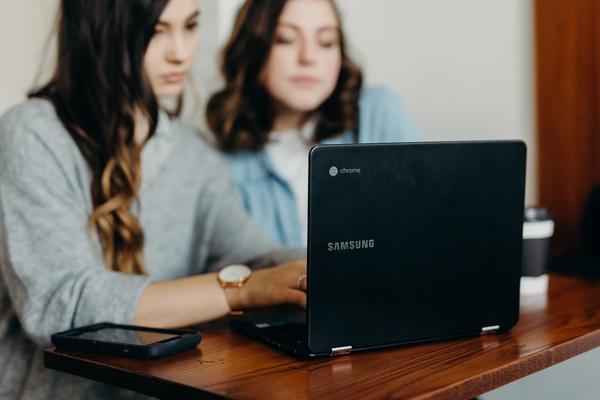 Two women working at a computer