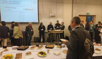 Image of the cocktail and project coordinator of Scale-Up on stage Image of the cocktail and project coordinator of Scale-Up on stage