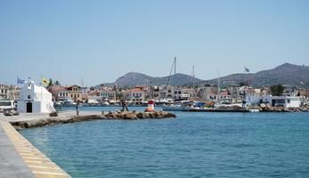 The harbour in Aegina island (Greece) with green mountains in the background.