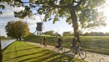 Cyclists along Bruges canals