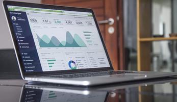 Image of data visualisation and graphs on a laptop screen