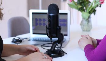Women at Podcast Microphone