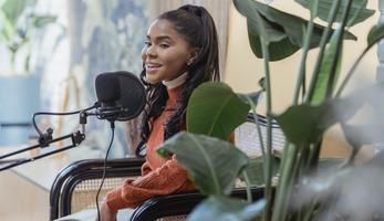 Young woman speaking into a microphone