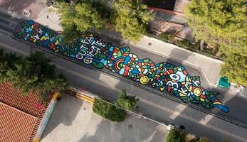 Aerial image of the largest asphalt mural in Greece, which includes the words "Outta Climate" and "30 km/hr"