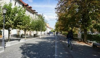 Man cycling through public square in Slovenia