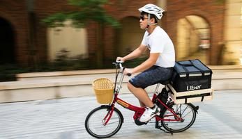 Man on a bicycle with a basket on the back