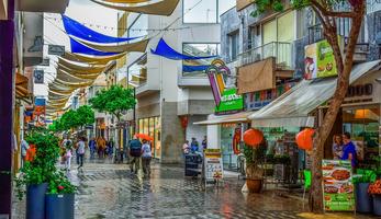 People walking along a large pedestrian street