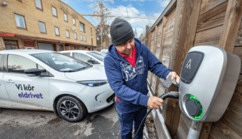 A man charging his e-vehicle in Bromma, Stockholm.