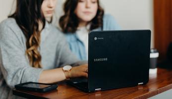 Two women working at a computer